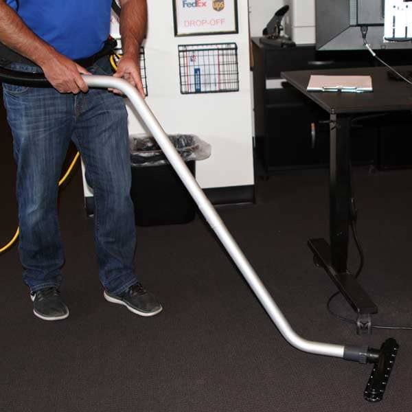Contractor using atlas backpack on a carpet