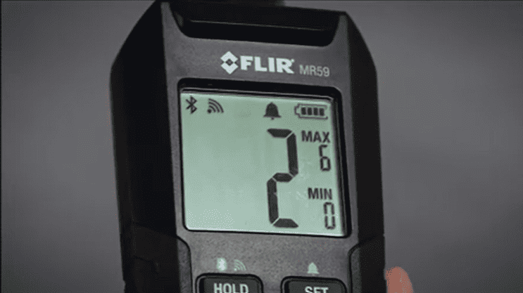 FLIR MR 59 device with digital display on a dark background