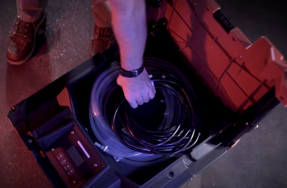 Person handling coiled cable inside a Phoenix Drymax XL Pro