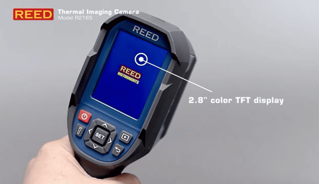 REED R2165 thermal imaging camera with 2.8" color TFT display held in a hand against a gray background