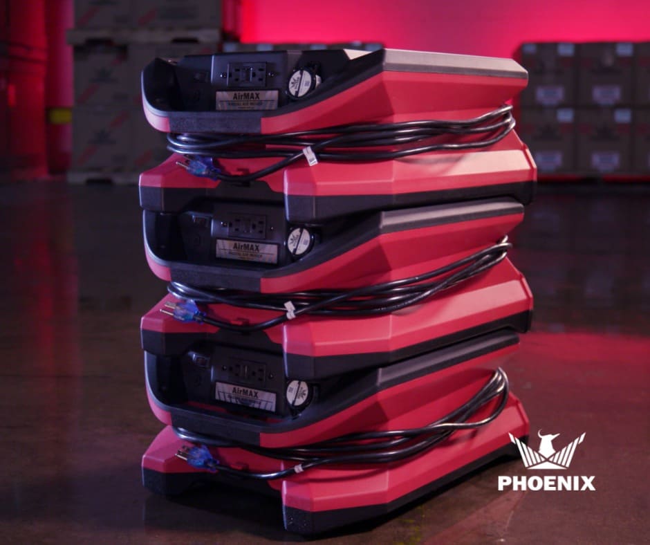 Stack of red and black AirMax Phoenix Radial BLE Air Movers on a dark background