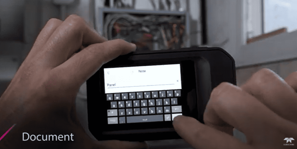 Person using a flir c5 digital Thermal camera device with a keyboard interface in an indoor setting.