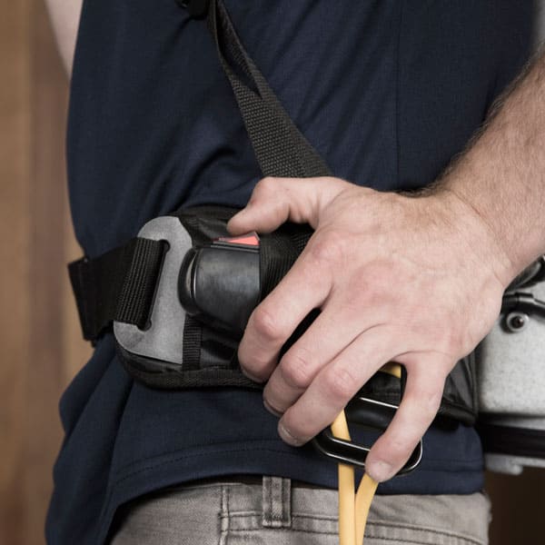 Man using power switch to turn on vacuum backpack cleaner