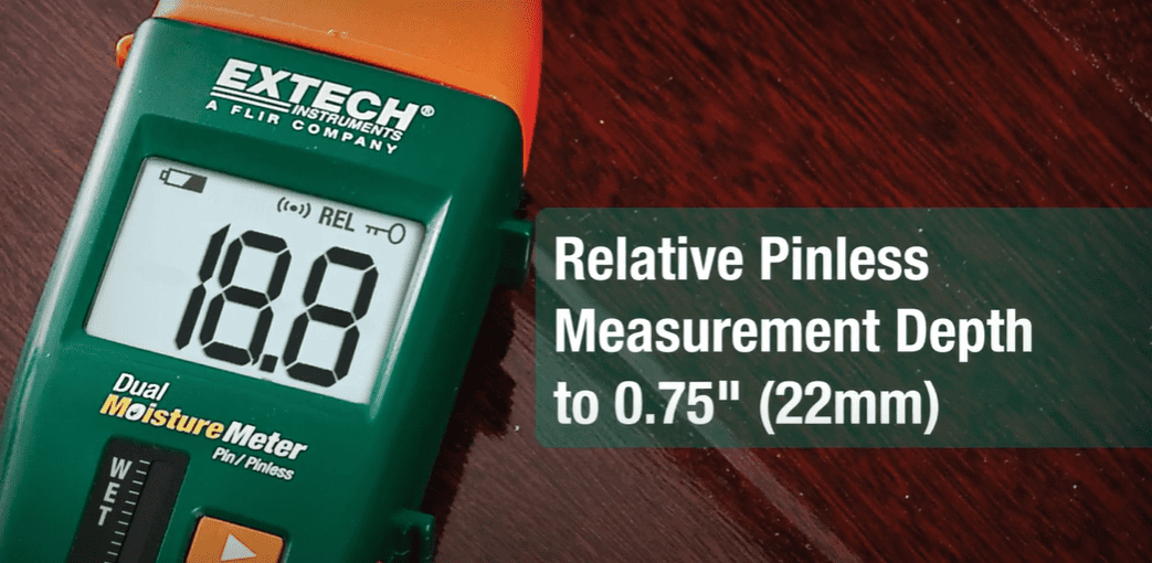 Extech mo260 dual moisture meter on a wooden surface with text indicating pinless measurement depth.