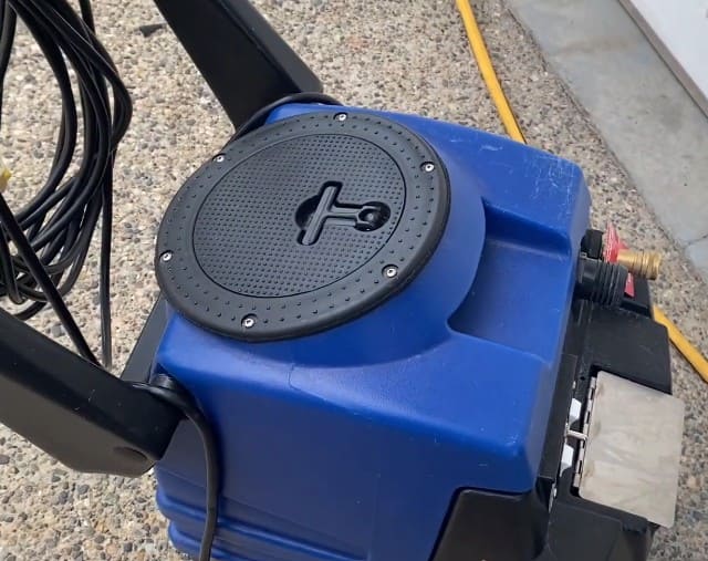 Blue and black Esteam E600 on a concrete surface with yellow cord