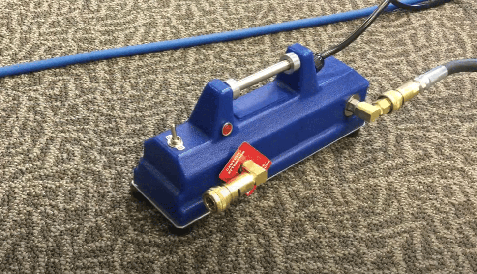 Blue External Heatermate with brass fittings on a textured surface