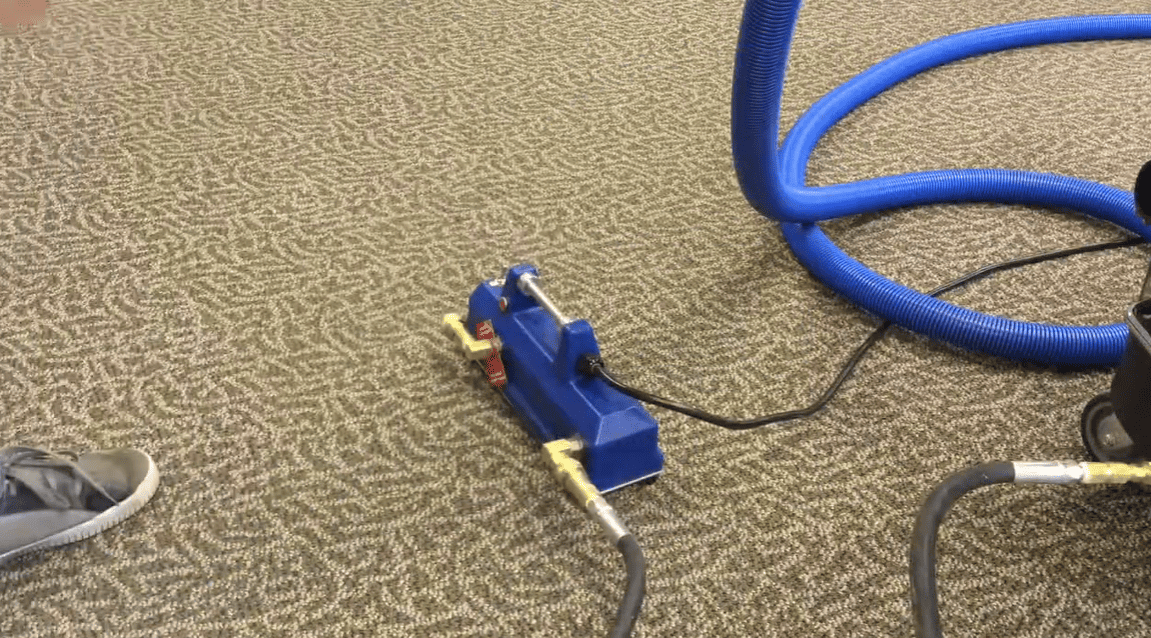 Blue External Heatermate on a beige carpet with a shoe nearby