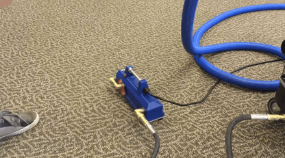 Blue External Heatermate on a beige carpet with a shoe nearby