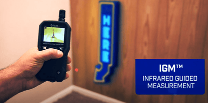 MR176 Hand holding an infrared measurement device with IGM logo on a wooden wall background