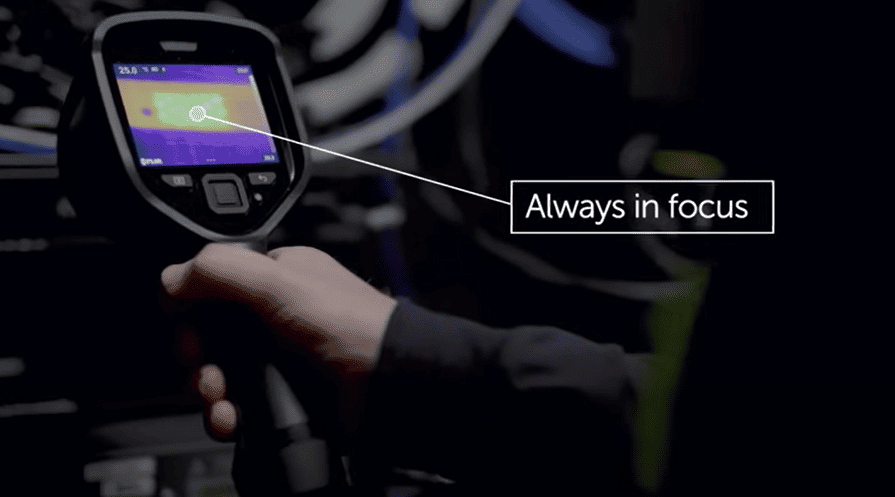 Flir E8 Pro hand holding a thermal imaging device with 'Always in focus' text overlay.