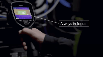 Flir E8 Pro hand holding a thermal imaging device with 'Always in focus' text overlay.