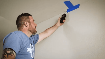 Person using a Flir MR59 with blue paint on a wall