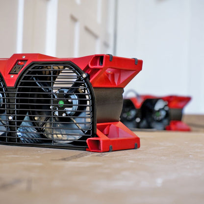 Phoenix Focus II Dual Axial Air Mover  on a wooden surface with a blurred background