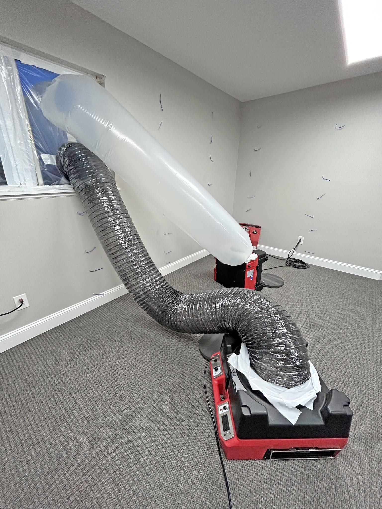 Phoenix Guardian R HEPA Air Scrubber on carpet with ducts connected