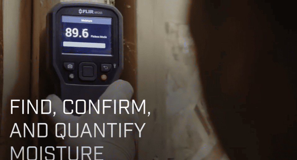 Moisture meter MR265 displaying a reading with text 'Find, confirm, and quantify moisture' on a blurred background.
