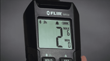 FLIR MR 59 device with digital display on a dark background