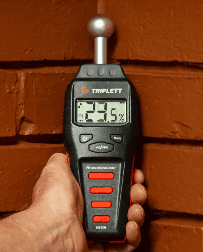 Triplett Ms300 Moisture meter in use on the wall