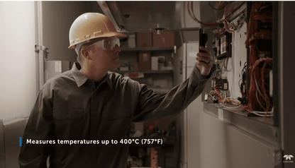 Person in a hard hat using a FLIR ONE Edge Pro thermal camera in an industrial setting with text about temperature measurement.