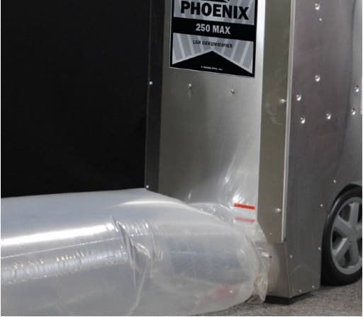 Metal dehumidifier with 'Phoenix 250 Max' label on a black background. ducting bag connected