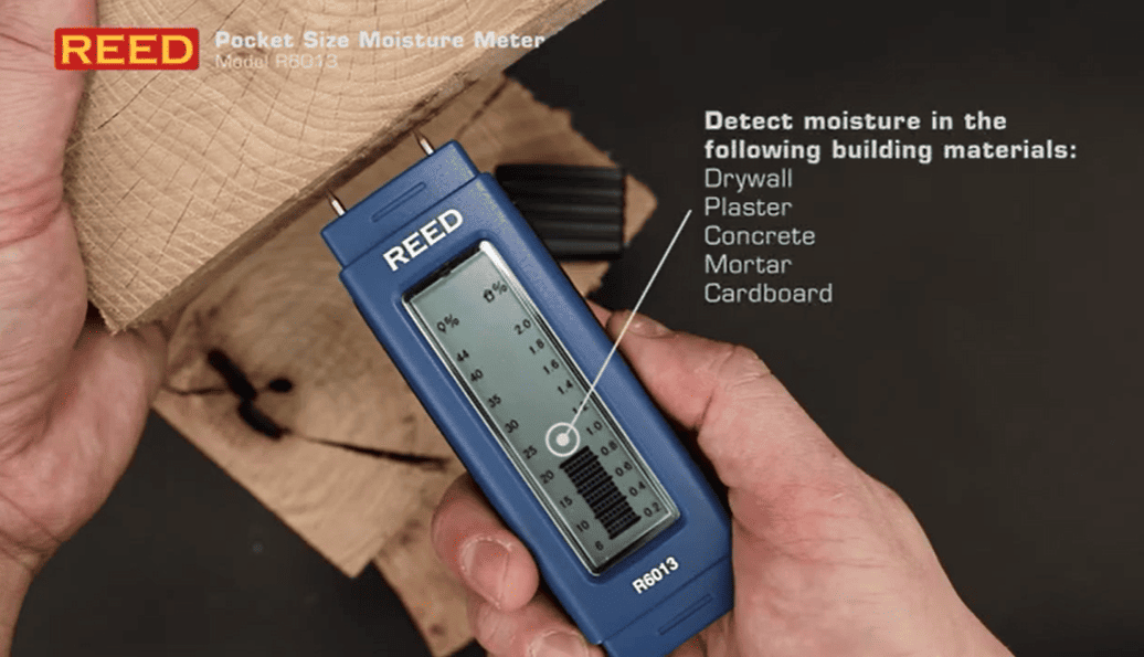 REED r6013 pocket size moisture meter being used on building materials with text indicating its use.