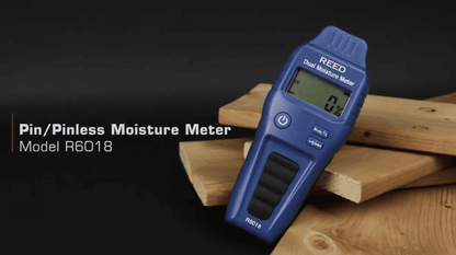 Blue moisture meter on wooden planks with 'REED' branding