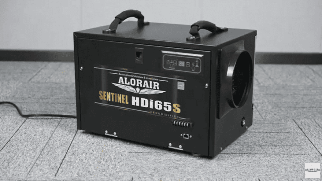 Black AlorAir Sentinel HDi65S Conventional Dehumidifier with 'AloAir' branding on a gray floor.