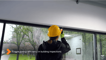 Person in a yellow hard hat inspecting a window using a FLIR TG268 with text about energy efficiency.