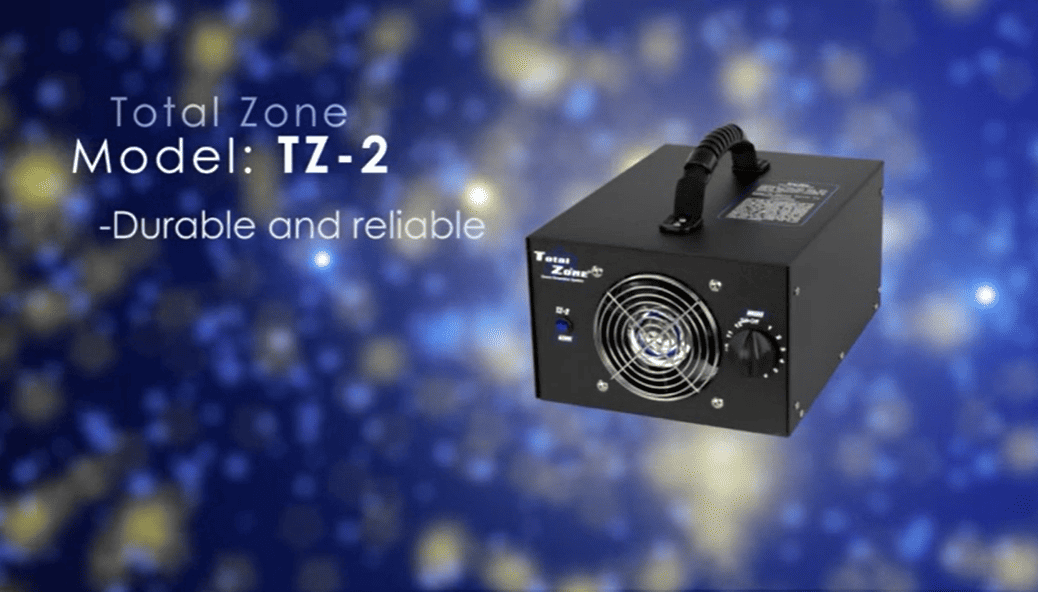 Black device labeled 'Total Zone Model: TZ-2' on a blue background with bokeh effect