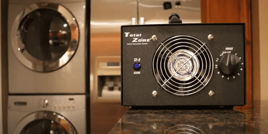 Black TZ-2 Total Zone on a kitchen counter, with washing machine in the background.