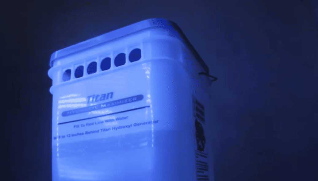 Titan Maximizer Blue-lit container with 'Titan' branding on a dark background