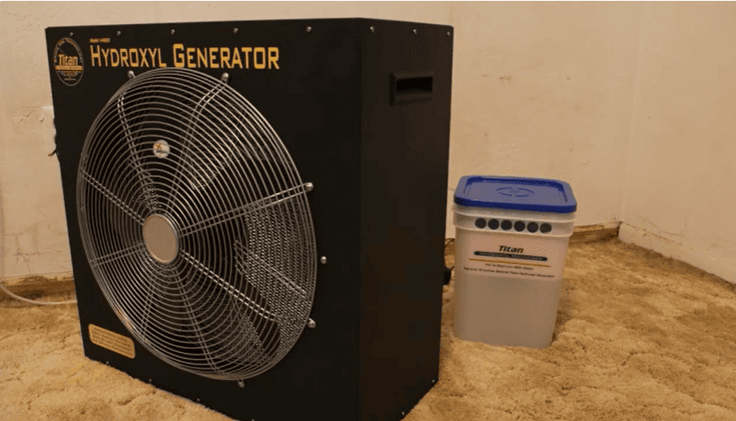 Titan 4000 Hydroxyl generator with a fan on a concrete floor next to a Maximizer