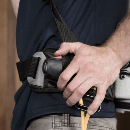 Man using power switch to turn on vacuum backpack cleaner