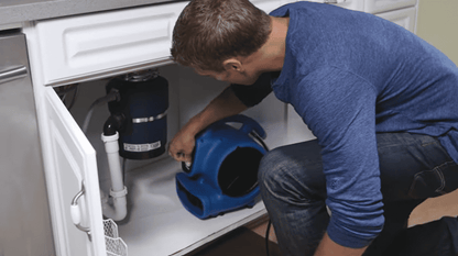 XPOWER X-830 1 HP Air Mover Man putting the air mover under the sink