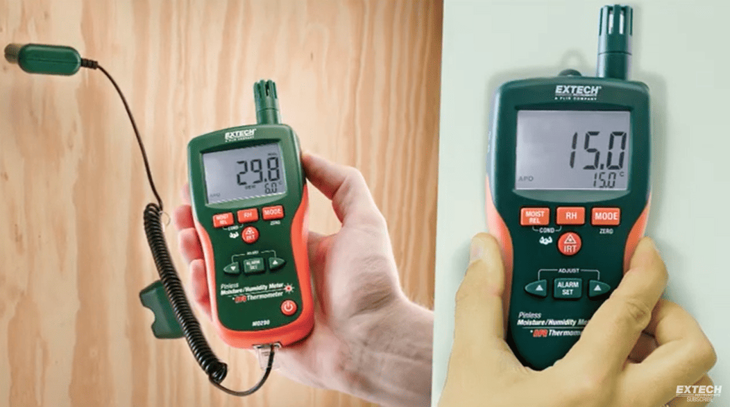 Two Extech mo290digital thermometers being held, one against a wooden surface and the other against a white wall.