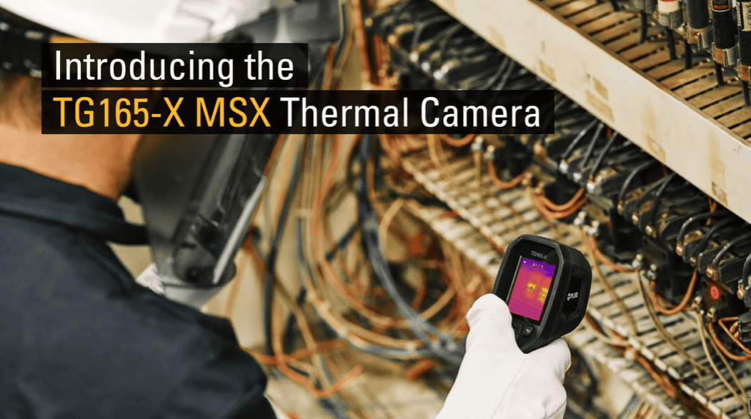 Person holding a TG165-X MSX Thermal Camera in an industrial setting.