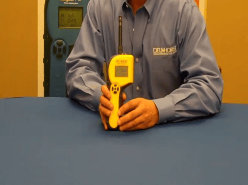 Person holding a ht 4000 in front on the blue surface