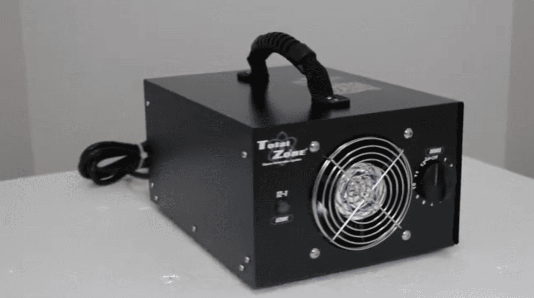 Black total zone tz 1 ozone generator facing right on a white surface