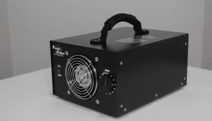Black total zone tz 1 ozone generator side view left facing on a white surface