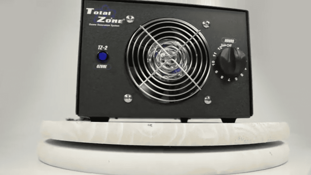 Black tz 2 ozone generator and control knobs on a white base against a gray background
