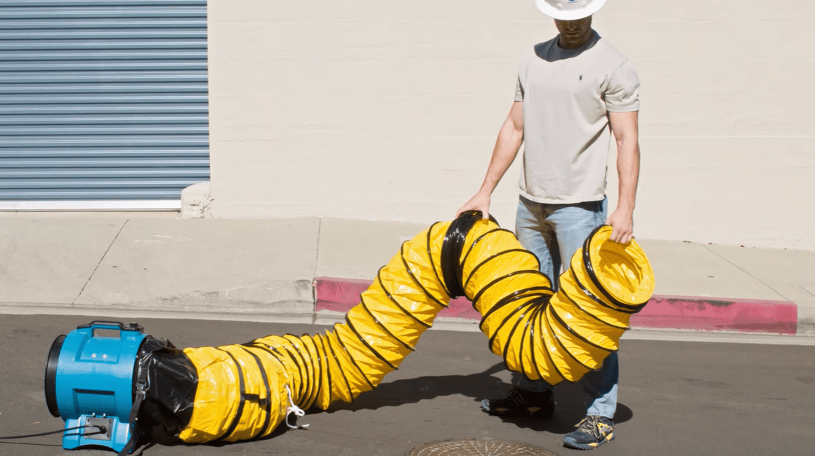 Person holding a large yellow hose connected to a x8 xpower